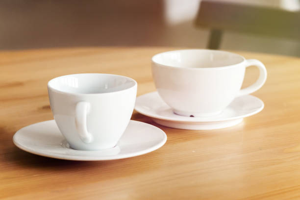 istock Two white ceramic cups on a table, home office concept. Could be used for interior decor 1215811922