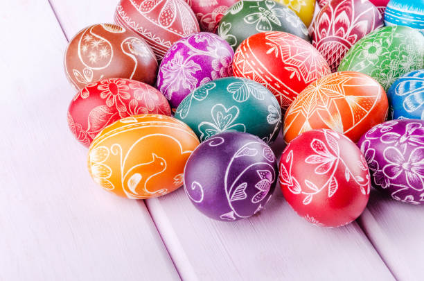 istock Variety of colorful handmade scratched easter eggs on wooden table 1215814370