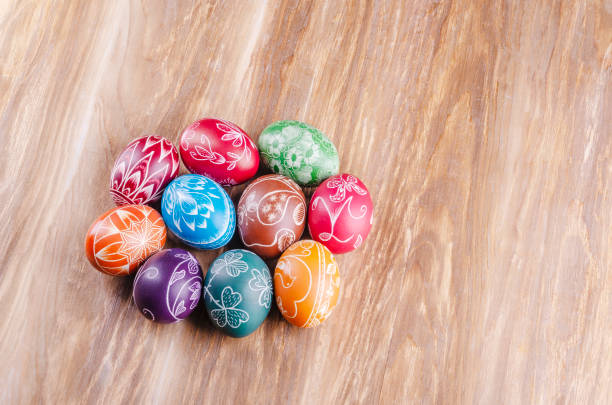 istock Variety of colorful handmade scratched easter eggs on wooden table 1215814375