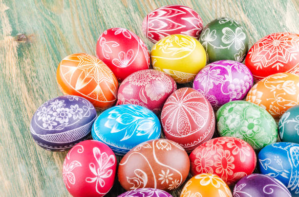 istock Variety of colorful handmade scratched easter eggs on wooden table 1215814384