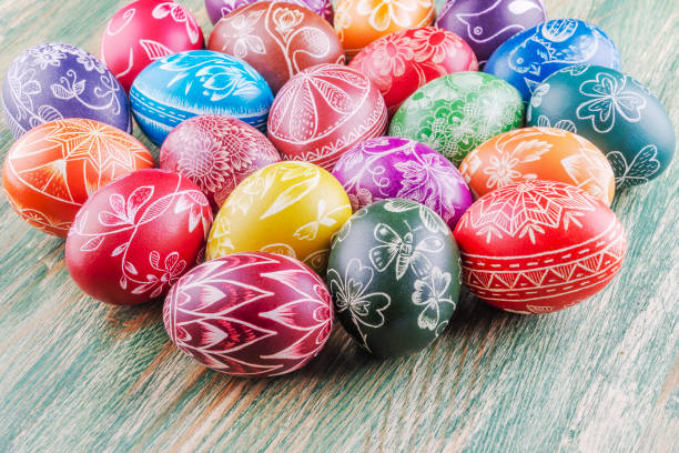 istock Variety of colorful handmade scratched easter eggs on wooden table 1215814436