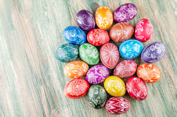 istock Variety of colorful handmade scratched easter eggs on wooden table 1215814438