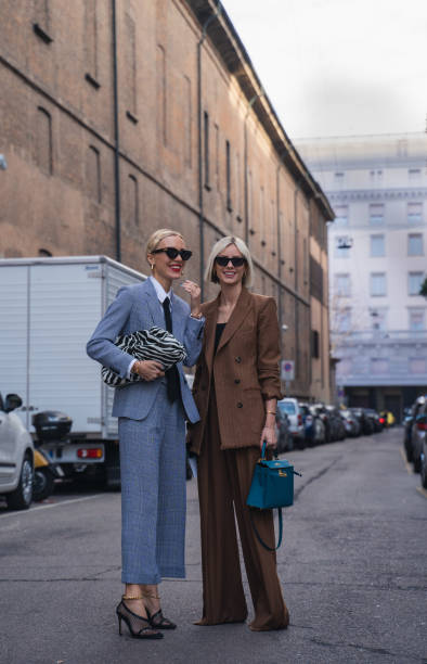 Milan, Italy - 20 February 2020: Stylish persons are posing for photographers before Max Mara fashion show on Milan Woman's Fashion Week F/W2020-2021, street style Bloggers and stylists inroduce new fashion looks before Maxmara show milan fashion week stock pictures, royalty-free photos & images