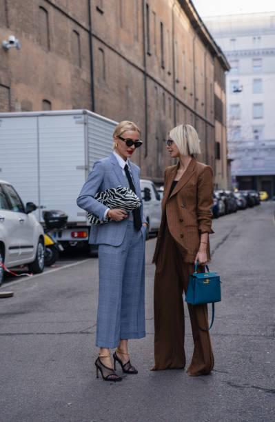 Milan, Italy - 20 February 2020: Stylish persons are posing for photographers before Max Mara fashion show on Milan Woman's Fashion Week F/W2020-2021, street style Bloggers and stylists inroduce new fashion looks before Maxmara show milan fashion week stock pictures, royalty-free photos & images