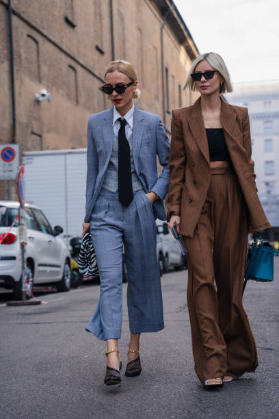 Milan, Italy - 20 February 2020: Stylish persons are posing for photographers before Max Mara fashion show on Milan Woman's Fashion Week F/W2020-2021, street style Bloggers and stylists inroduce new fashion looks before Maxmara show street fashion stock pictures, royalty-free photos & images