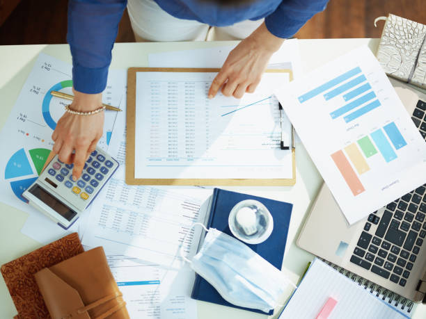 istock business woman working with documents and calculator at table 1215817021