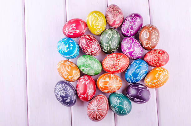 istock Variety of colorful handmade scratched easter eggs on wooden table 1215817400