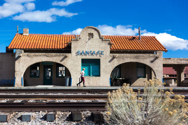 Santa Fe, NM: A lone jogger running past the Santa Fe train station in the Guadalupe district of Santa Fe.