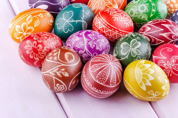 istock Variety of colorful handmade scratched easter eggs on wooden table 1215818252