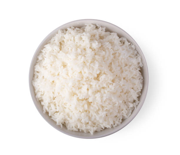 istock Rice in a white bowl on a white background. top view 1215818291