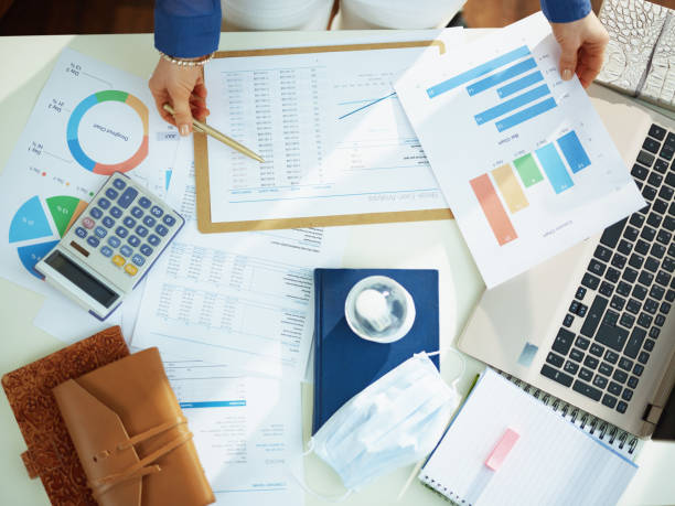 istock Upper view of business woman working with documents at table 1215818507