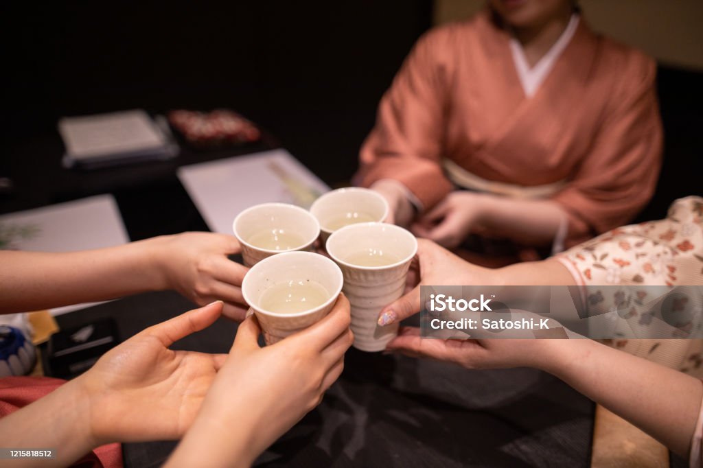 Young women in kimino celebratory toasting at Japanese restaurant Young women in kimono celebratory toasting at Japanese restaurant Saki Stock Photo