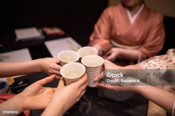 Young Women In Kimino Celebratory Toasting At Japanese Restaurant Stock Photo - Download Image Now