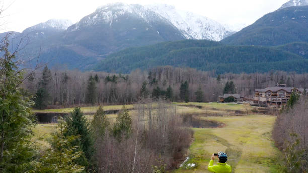 istock Mountain biker takes photo of mountain range 1215819372