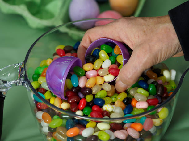 istock Kids Easter Treat Jellybeans in Plastic Eggs Hand Held 1215819406