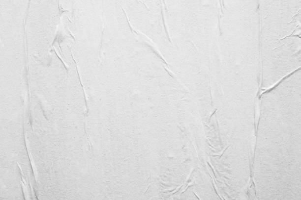 istock Blank white crumpled and creased paper poster texture background 1215820864