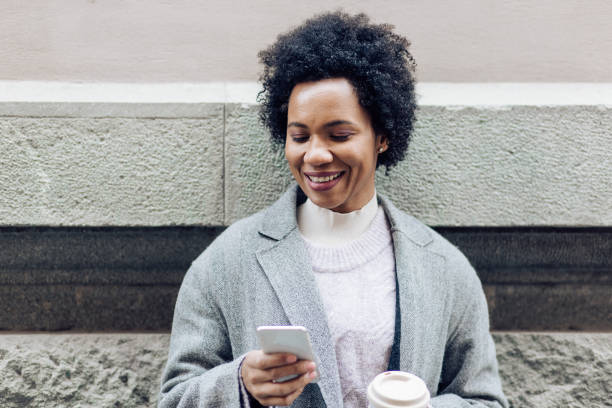 istock Curly hair woman typing a message 1215820872