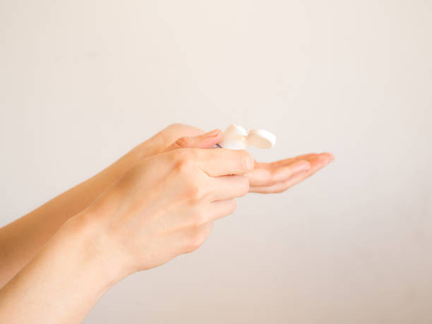 istock Female hands cleaning with sanitizer gel 1215821156