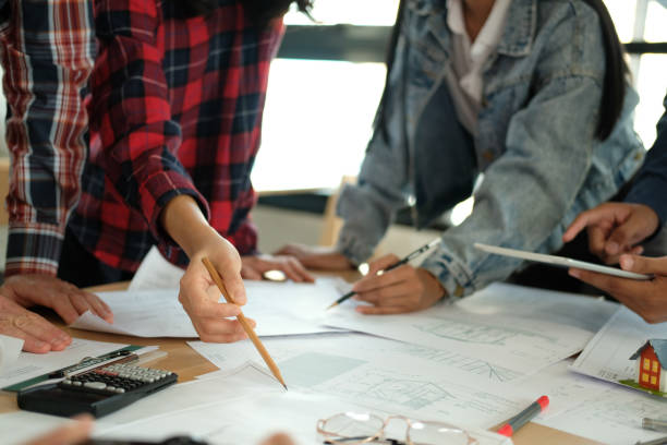 istock architect engineer team working discussing on house blueprint of real estate project in meeting 1215821177