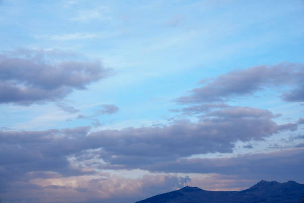 yellow and orange clouds at sunset. dramatic sky skyline background with mountain