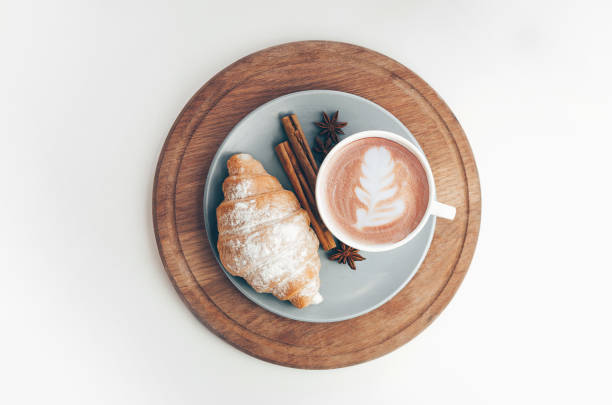 istock Fresh baked croissant with coffee cup and latte art, cinnamon 1215823390