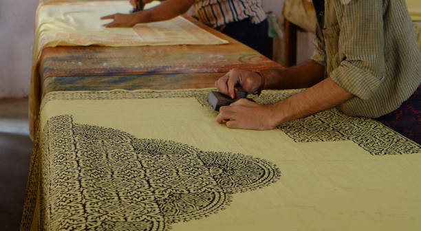 istock Pressing woodblocks against a cloth to make a pattern on the cloth 1215823411