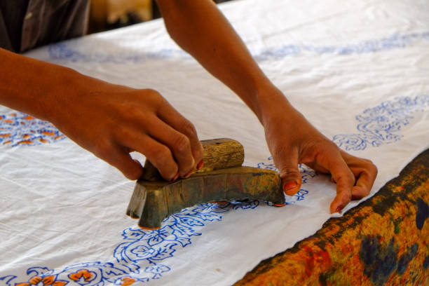 istock Pressing woodblocks against a cloth to make a pattern on the cloth 1215823415