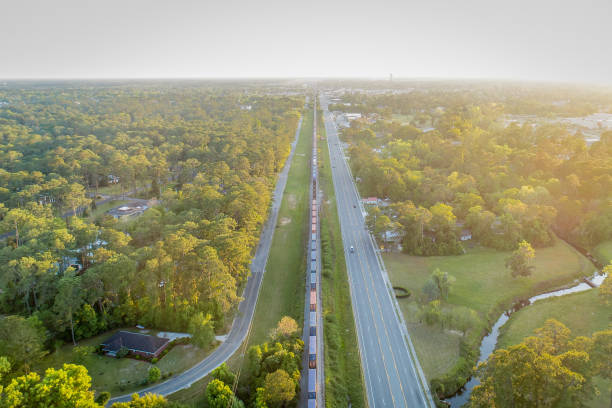 istock Highway and Railroad Track Leading into Small Town 1215828855