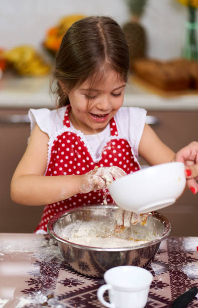 istock Young girl cooking a pastry 1215829200