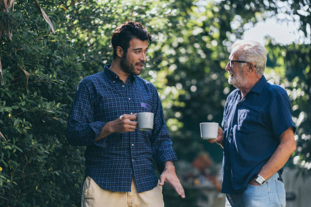 istock Old father and son, Morning coffee in a garden 1215832156