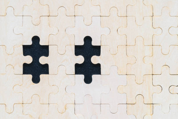 istock Close up wooden jigsaw puzzle pieces on black background 1215835717