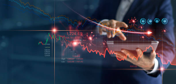 istock Economic crisis, Businessman using tablet analyzing sales data and economic graph chart that is falling due to the corona virus crisis, Covid-19, stock market crash caused. 1215836469