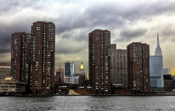 NY Cityscape down E 26th from East River New York cityscape taken from boat on East River photographed down E 26th Street.  Overcast sky, HDR processed to enhance image. new york life building stock pictures, royalty-free photos & images