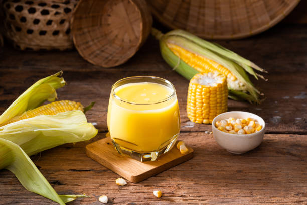 Fresh sweet corn juice (corn milk) and corn on wood background stock photo