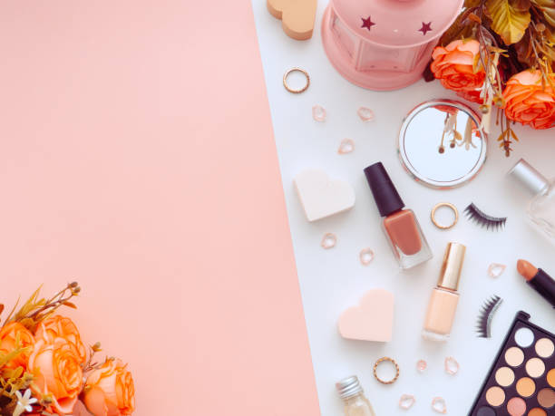 istock Makeup tools cosmetics, nail polish, sponge, lipstick, eyeliner, false eyelashes, perfume, eyeshadows, puff, rose flowers isolated on white and pink background 1215843954