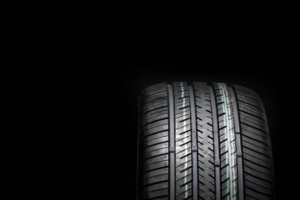 istock Brand new tire on a black background 1215847747