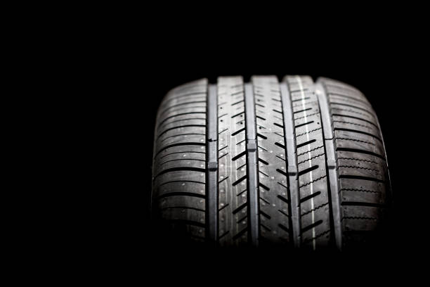 istock Brand new tire on a black background 1215847773
