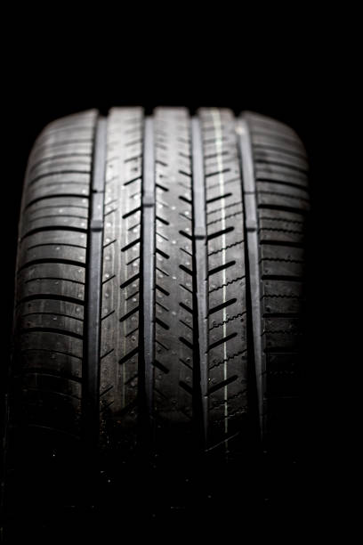 istock Brand new tire on a black background 1215847782