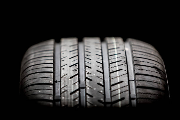 istock Brand new tire on a black background 1215847784