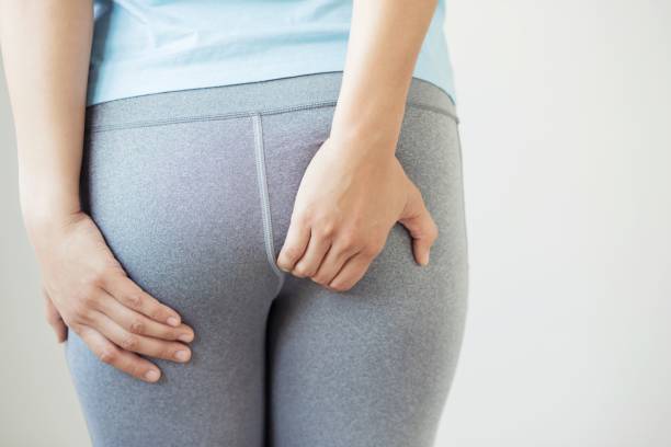 Women with ass pain caused by hemorrhoids Women with ass pain caused by hemorrhoids man touching womans buttock stock pictures, royalty-free photos & images