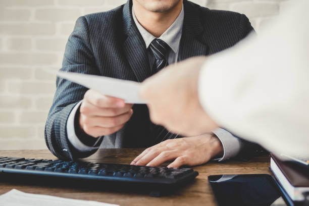 Businessman passing document to manager in the office