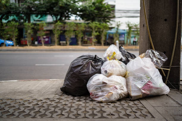 istock Bags of garbage left on footpath 1215853699