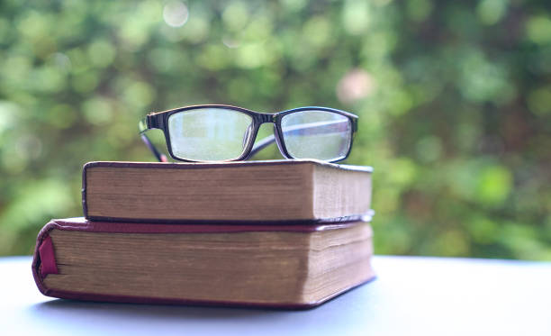 istock Reading glasses on top of books 1215854079