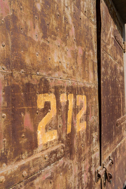 istock Old weathered rusty factory gate with number 1215855300