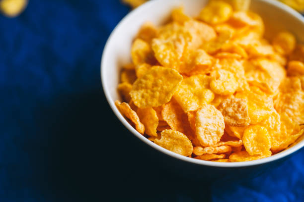 istock Tasty crispy corn flakes in bowl on the rustic background 1215856268