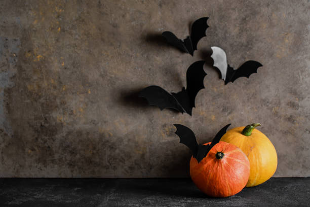 istock Halloween pumpkins and bats on a dark background 1215856299