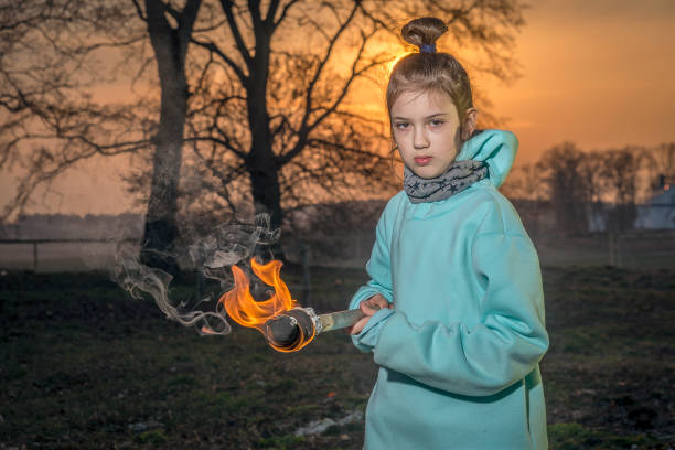 istock A girl with a burning torch. 1215857271