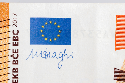 Europe union flag and Mario Draghi's signature on 50 Euro banknote. Mario Draghi is president of the European Central Bank.