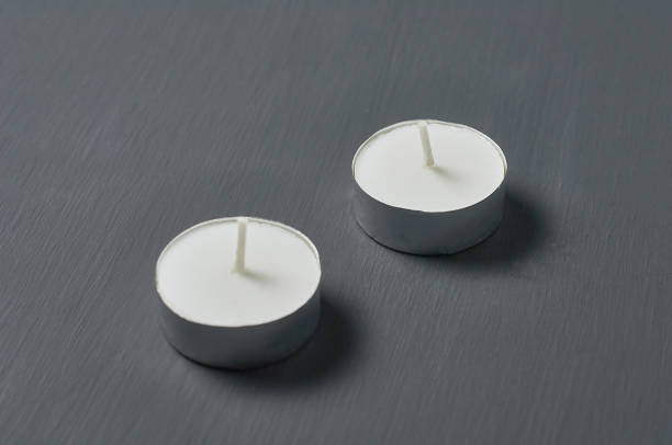 istock Two circle candle in metal holder on dark concrete surface 1215857597