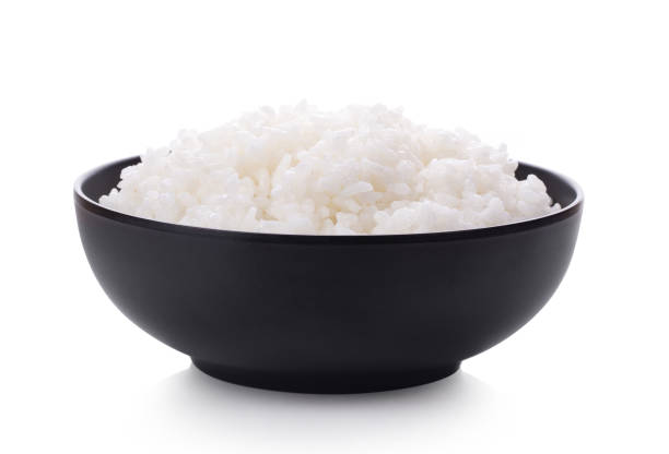 istock Rice in a black bowl isolated on a white background 1215861114